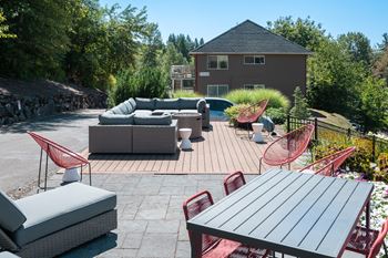 A patio with a table and chairs and a couch.
